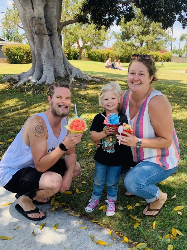 Family enjoying shave ice at a park event