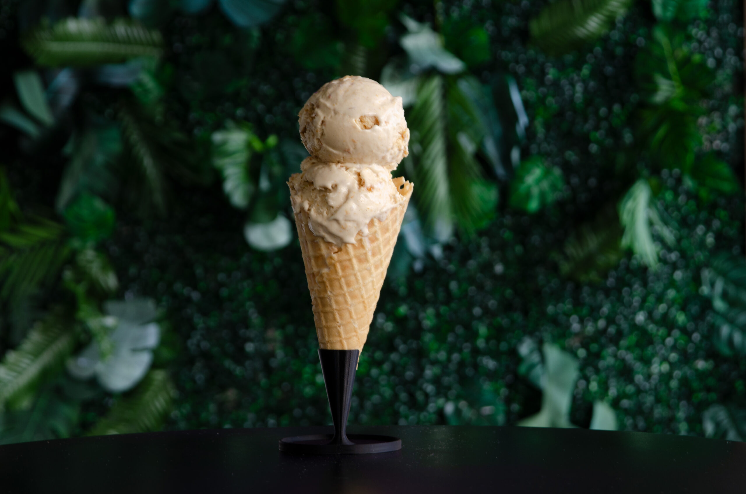 Peach cobbler ice cream in a waffle cone